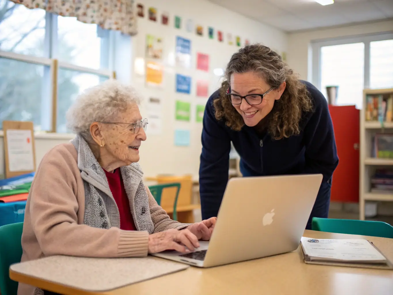A photograph of a workshop at BIBLIOTHEQUE focused on digital literacy for seniors. Participants are actively engaged with laptops, learning essential computer skills under the guidance of an instructor.