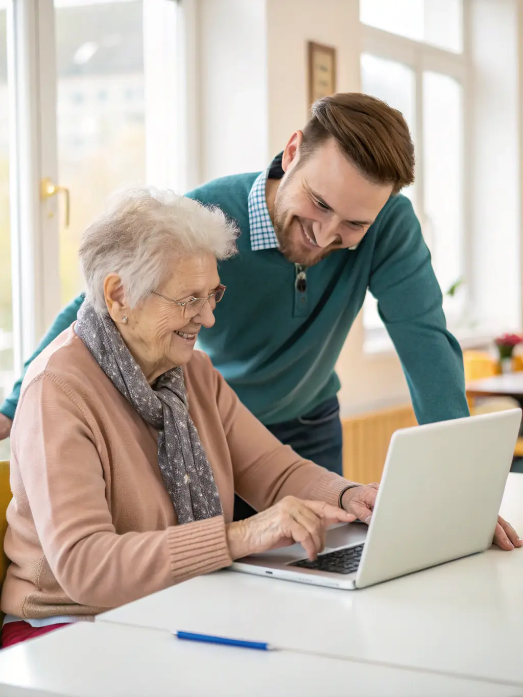 Seniors participating in a computer literacy class at the library, with instructors guiding them through basic computer skills and internet navigation.